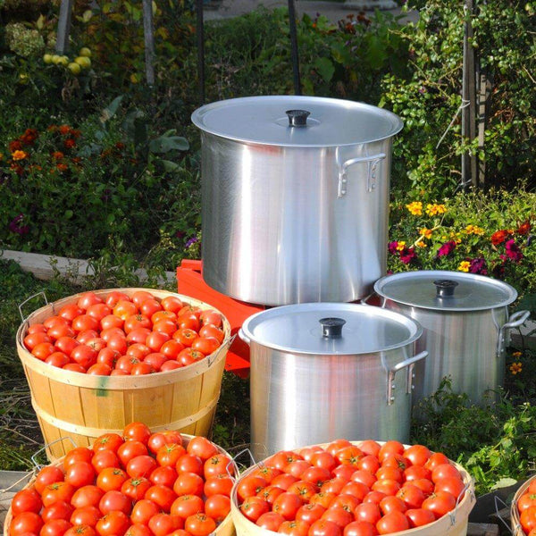 148 Q / 140L Stock Pots with Lid outside with bushels of tomatoes in front of it - Crown Cookware