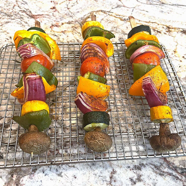 Cooling Rack for Baking / Roasting with three skewers of roasted vegetables - Crown Cookware